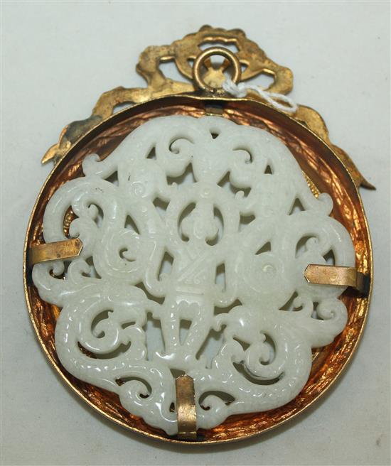 A Chinese white hardstone plaque, diam. 7.6cm